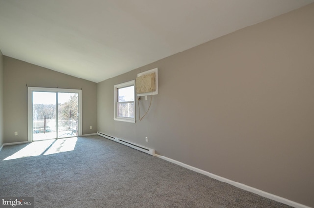 spare room with a baseboard heating unit, dark carpet, lofted ceiling, and baseboards