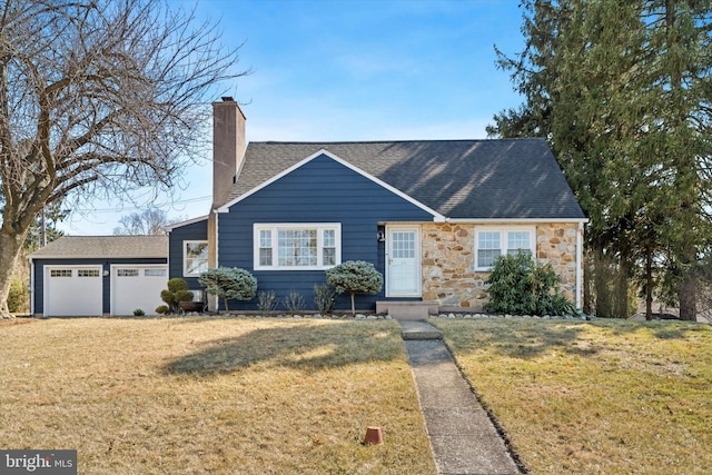 view of front facade featuring a front yard, roof with shingles, an attached garage, a chimney, and stone siding