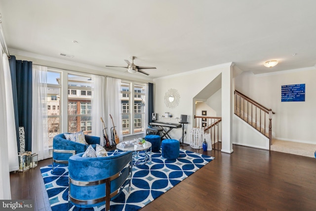 living area with baseboards, ornamental molding, an upstairs landing, wood finished floors, and a ceiling fan