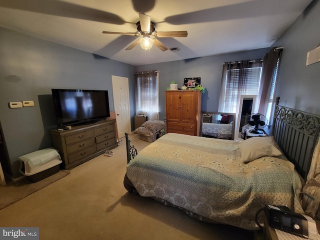 bedroom featuring carpet flooring, ceiling fan, and visible vents