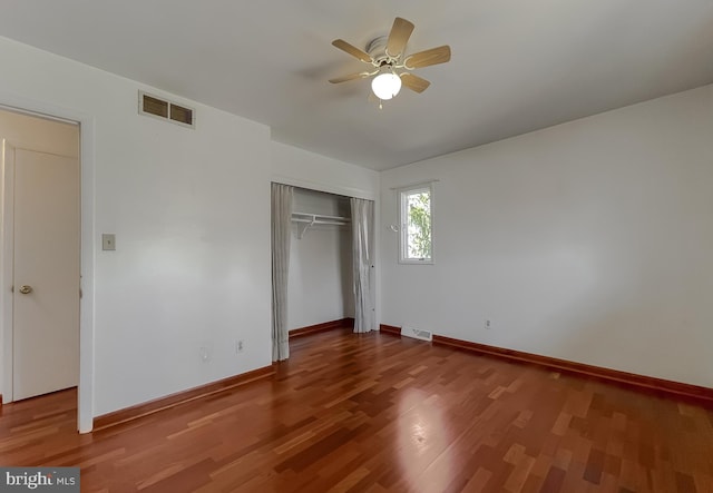 unfurnished bedroom featuring visible vents, baseboards, and wood finished floors