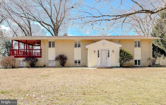 view of front of house with a front yard, brick siding, and a chimney