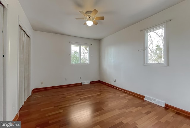 unfurnished bedroom featuring visible vents, light wood-style flooring, and baseboards