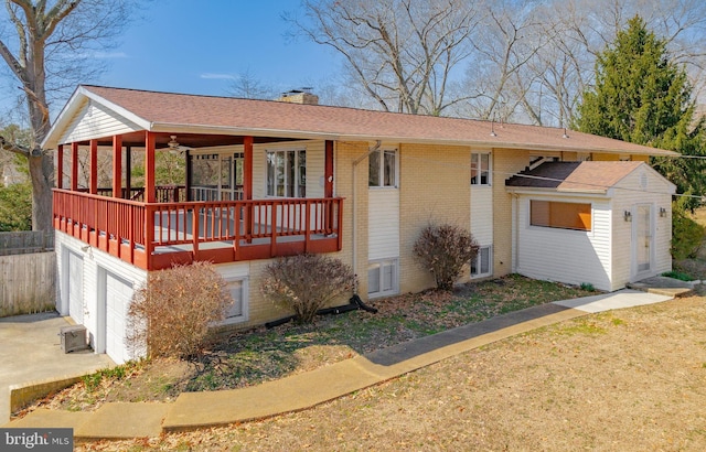 ranch-style house with brick siding, an attached garage, and a chimney