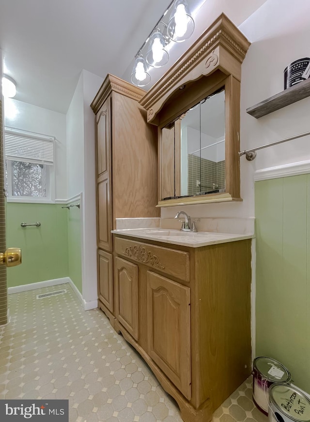 bathroom with tile patterned floors, visible vents, vanity, and baseboards