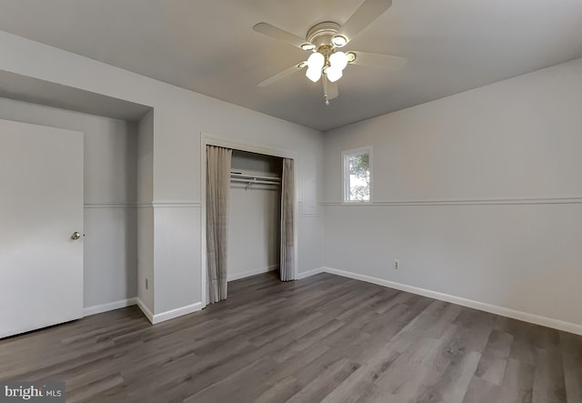 unfurnished bedroom featuring a closet, baseboards, a ceiling fan, and wood finished floors