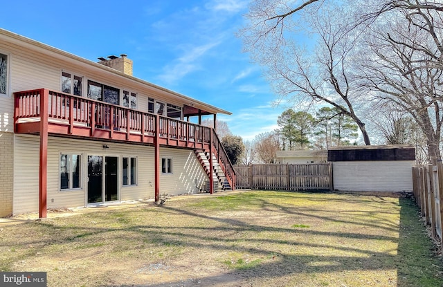 view of yard with an outbuilding, stairway, a shed, a fenced backyard, and a deck