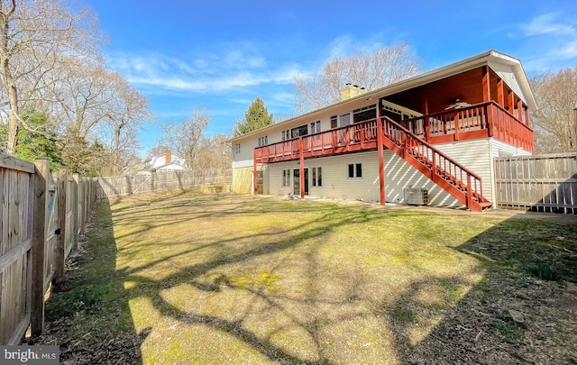 rear view of house featuring stairway, a yard, central AC unit, and a fenced backyard