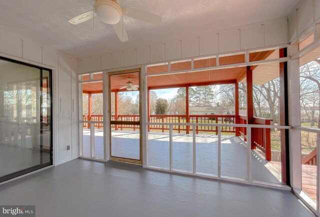 unfurnished sunroom with ceiling fan