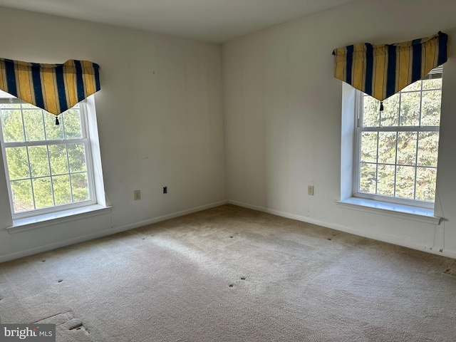 empty room with baseboards and carpet floors