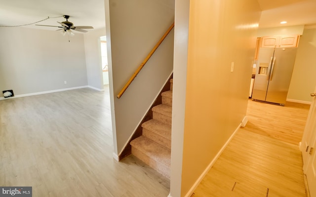 stairs with a ceiling fan, recessed lighting, wood finished floors, and baseboards