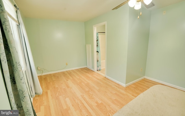 unfurnished bedroom with ceiling fan, baseboards, and wood finished floors