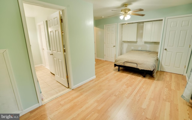 unfurnished bedroom featuring a ceiling fan, baseboards, and light wood finished floors