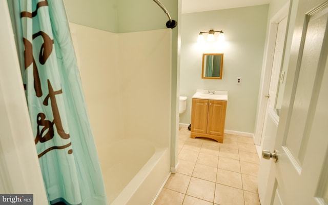 full bath featuring tile patterned flooring, shower / tub combo, vanity, and baseboards