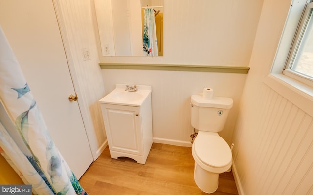 full bathroom featuring toilet, vanity, and wood finished floors