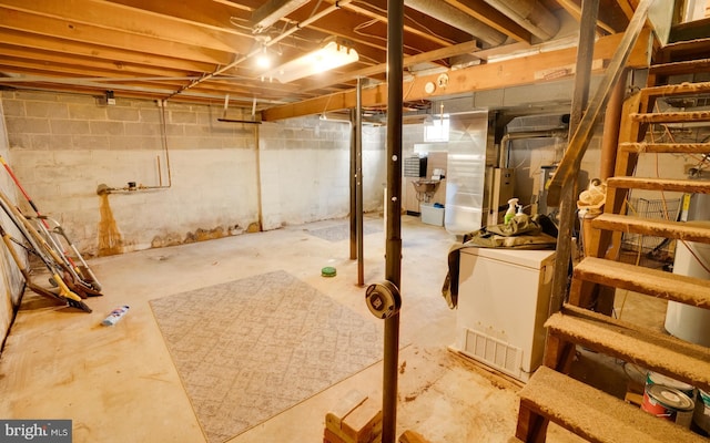 unfinished basement featuring refrigerator