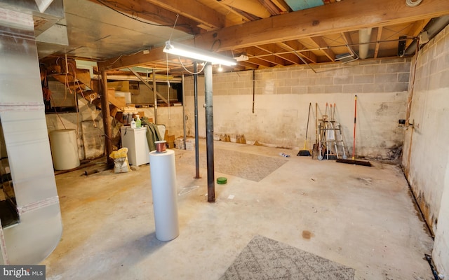 unfinished basement featuring washer / dryer