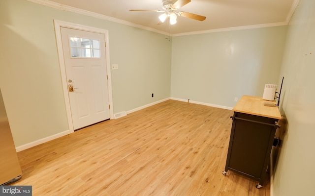 entrance foyer with a ceiling fan, light wood-type flooring, baseboards, and ornamental molding