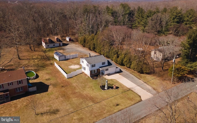 birds eye view of property featuring a wooded view