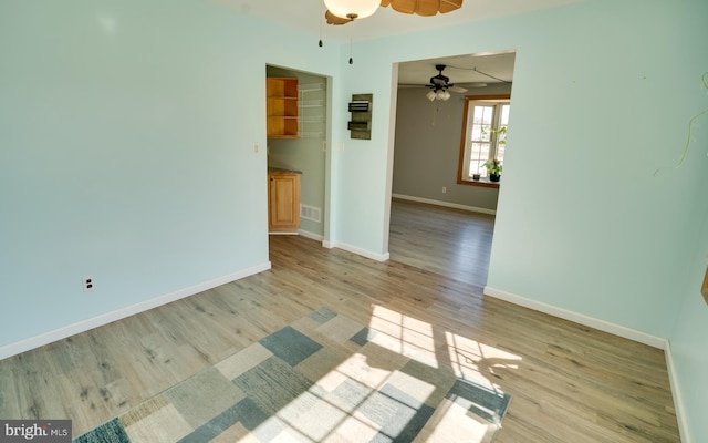 unfurnished room with visible vents, baseboards, and light wood-style floors