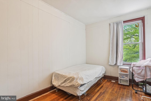 bedroom featuring baseboards and wood-type flooring