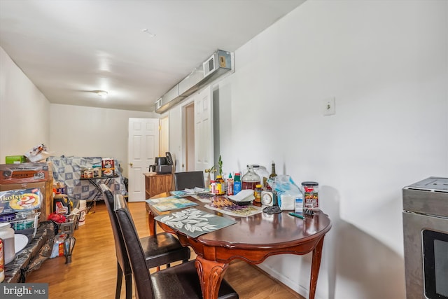 dining room featuring visible vents and wood finished floors