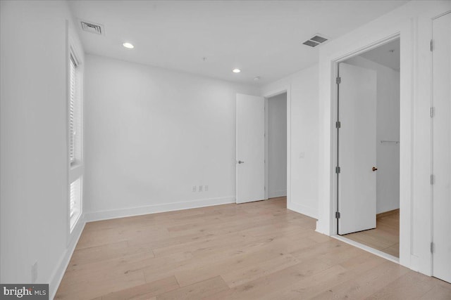 unfurnished bedroom featuring recessed lighting, visible vents, baseboards, and light wood-style floors