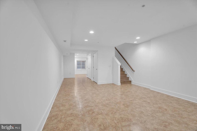 unfurnished living room featuring recessed lighting, stairs, and baseboards