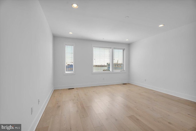 unfurnished room featuring recessed lighting, visible vents, baseboards, and light wood finished floors