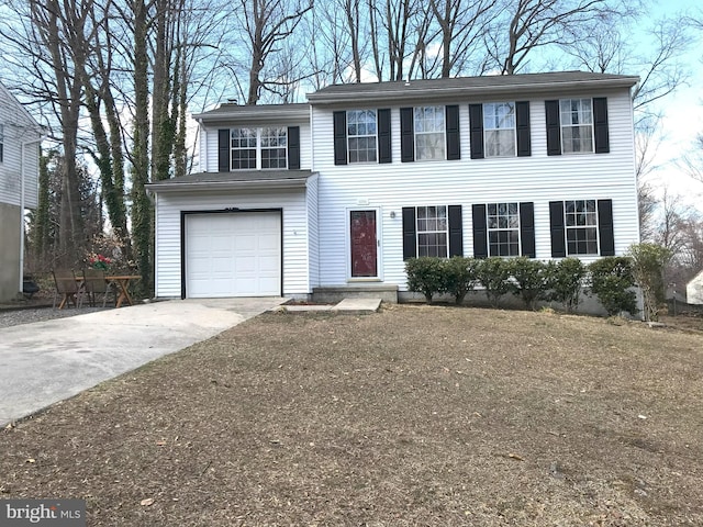 colonial-style house with driveway and a garage