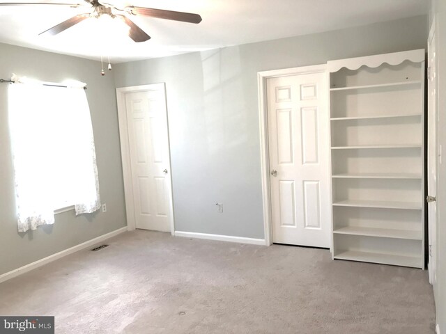 unfurnished bedroom featuring visible vents, a ceiling fan, baseboards, and carpet floors