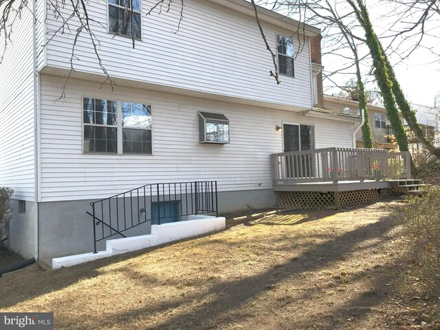 rear view of house with a wooden deck