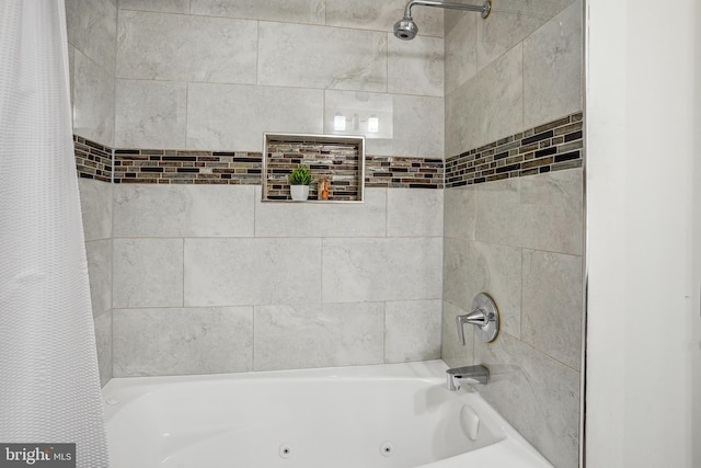 bathroom with a combined bath / shower with jetted tub