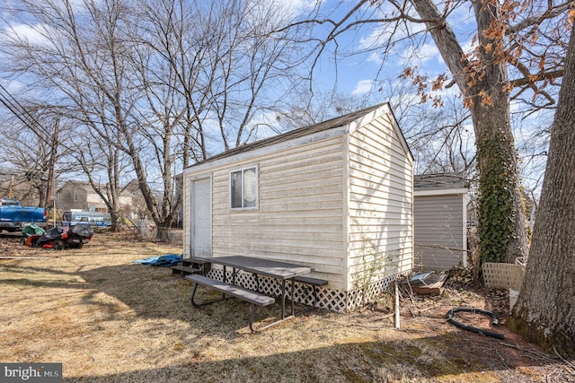 view of outbuilding featuring an outdoor structure and fence