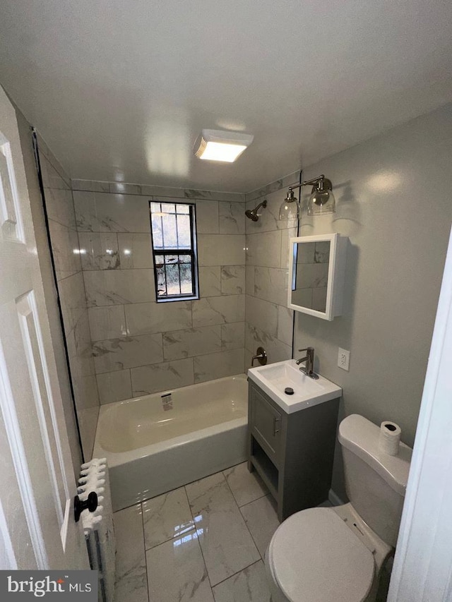 bathroom featuring toilet, marble finish floor, shower / bathtub combination, radiator, and vanity