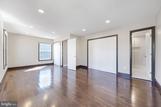 unfurnished bedroom with dark wood-type flooring, recessed lighting, baseboards, and visible vents