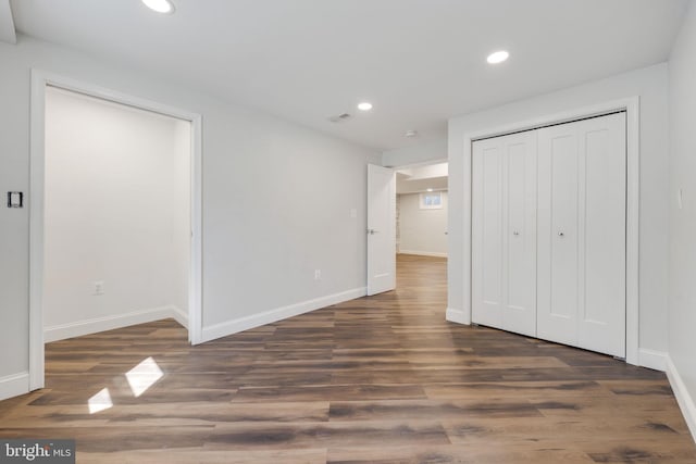 unfurnished bedroom featuring visible vents, recessed lighting, baseboards, and wood finished floors