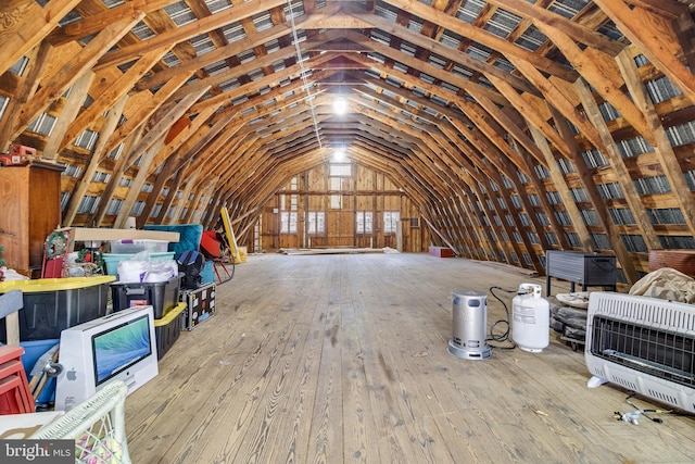 unfinished attic featuring heating unit