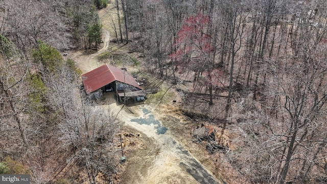 drone / aerial view featuring a wooded view