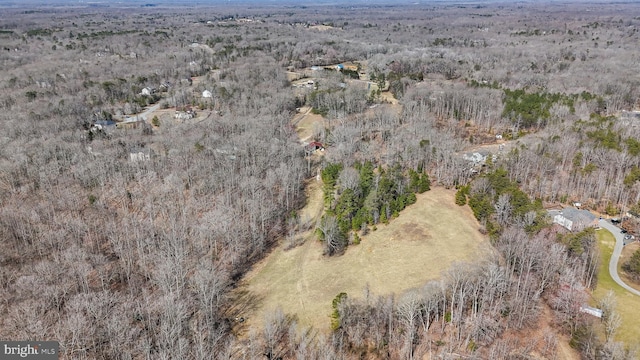 bird's eye view with a wooded view