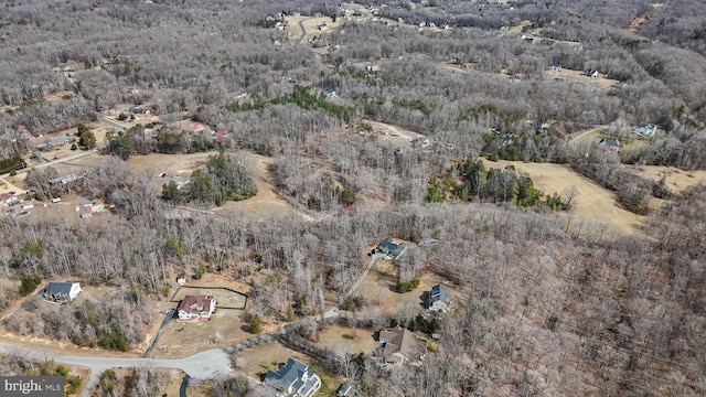 bird's eye view featuring a wooded view