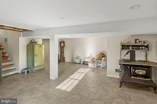 finished basement with stairway and baseboards