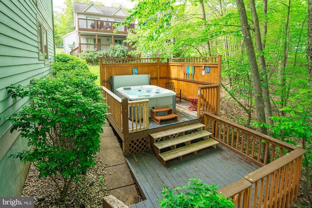 wooden deck with a hot tub