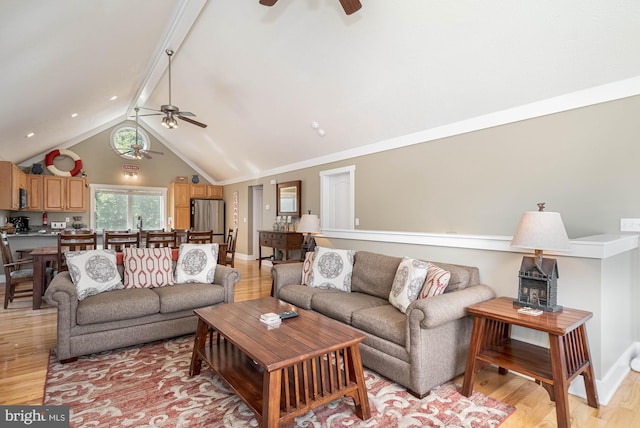 living room with baseboards, ceiling fan, lofted ceiling with beams, and light wood finished floors