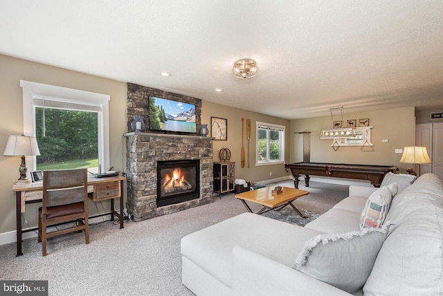 carpeted living area featuring a fireplace, billiards, a textured ceiling, and baseboards