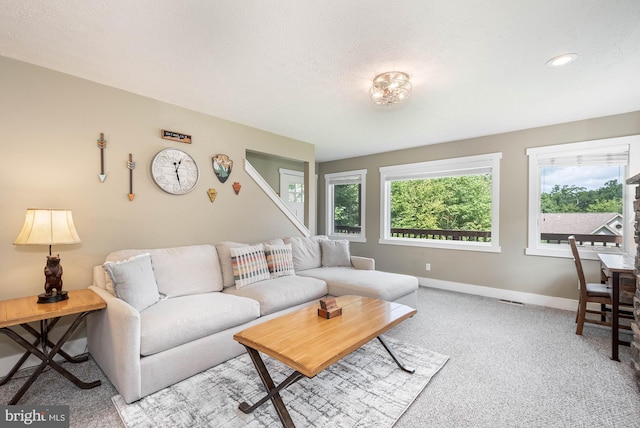 living room featuring a textured ceiling, recessed lighting, visible vents, and baseboards