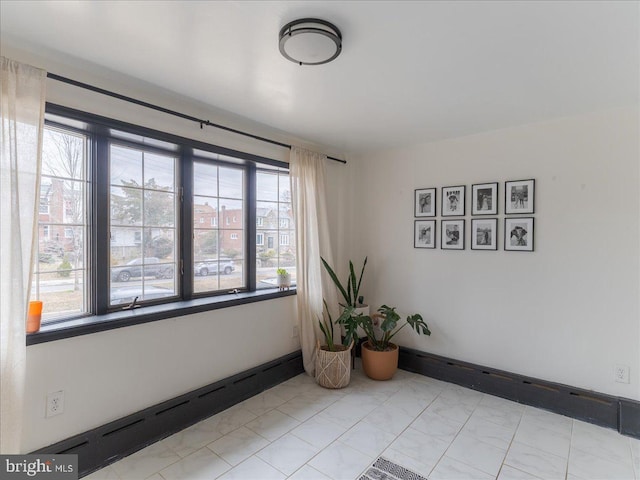 empty room featuring baseboards