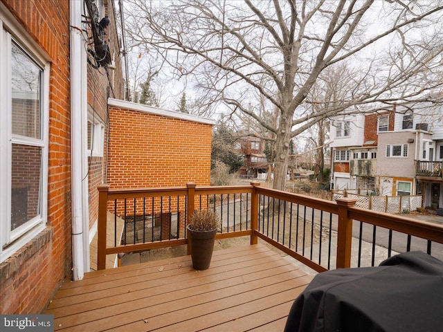 deck with area for grilling and a residential view