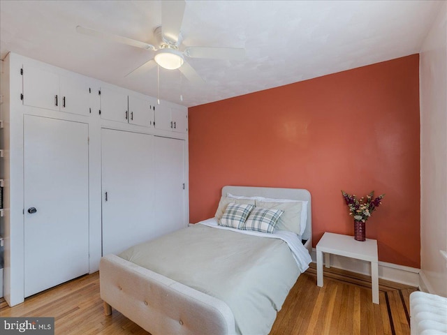 bedroom with a closet, ceiling fan, and light wood finished floors