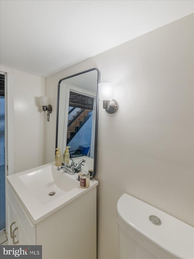 half bathroom with toilet and vanity